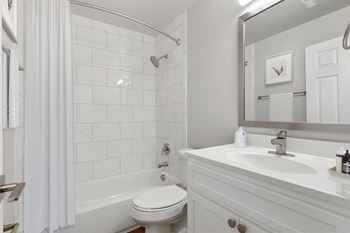 A bathroom with a bathtub and a sink